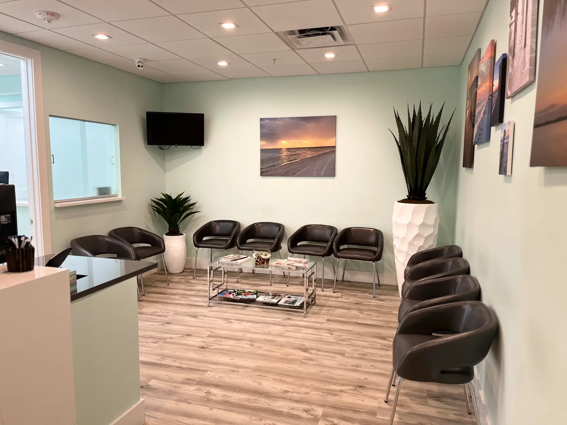 Bright waiting room with chairs, plants, and seaside decor